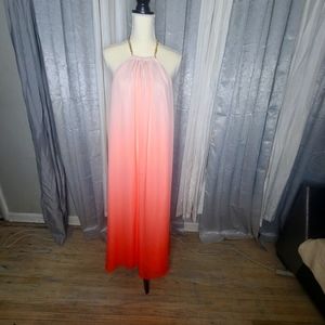 Jennifer Lopez tangerine colored ombre backless dress gold chain around kneck